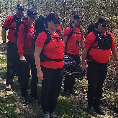 group of volunteers carrying a stretcher during training